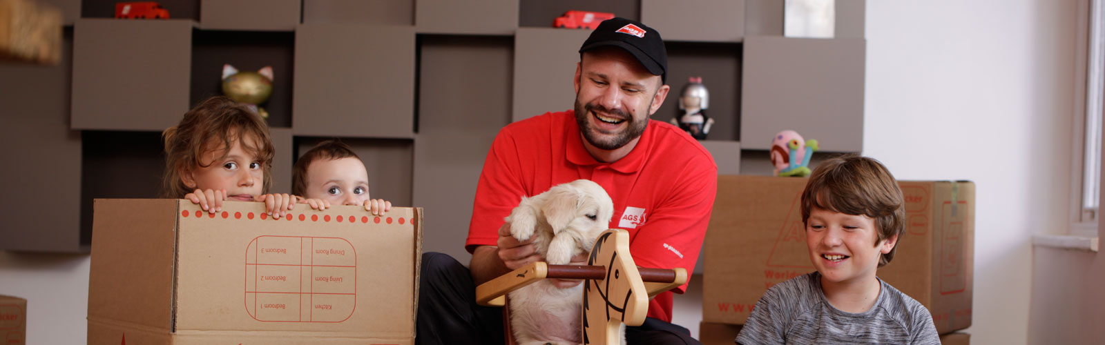 Removals guy unpacking with kids.